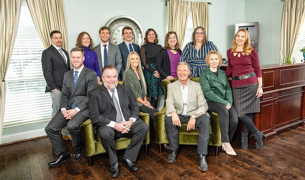 A professional photo of the whole CSRP team in a living room setting.